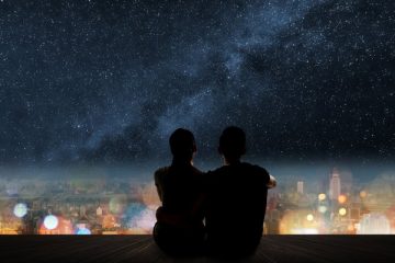 A couple is silhouetted under the stars