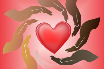 Hands in various skin tones surround a heart